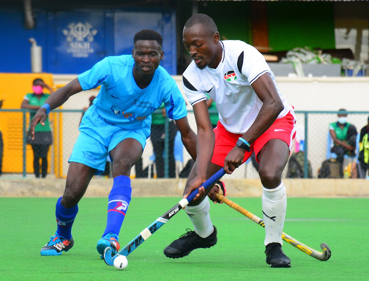 Kenya's Victor Osiche (R) challenges Maxwell Mugisha of Uganda during their test match at Sikh Union.