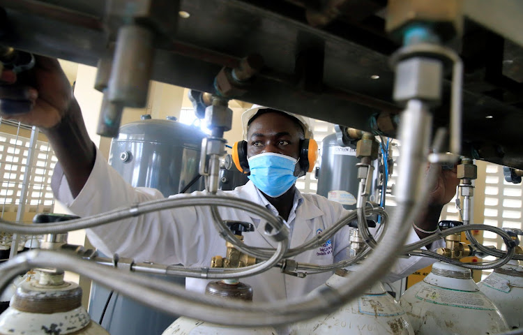 Bernard Olayo, founder of Hewatele, an innovative oxygen supply company,, checks filled oxygen medical cylinder tanks amid the coronavirus disease (COVID-19) pandemic, ahead of delivery to health facilities at the Hewatele oxygen plant in Nairobi, Kenya August 3, 2021. Picture taken August 3, 2021. REUTERS/Thomas Mukoya