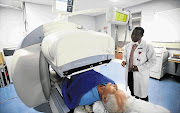 C CHANGE: Mike Sathekge, head of nuclear medicine at the University of Pretoria, with Walter Pike as the latter goes under the gamma camera in Steve Biko Academic Hospital, where he is being treated for prostate cancer.