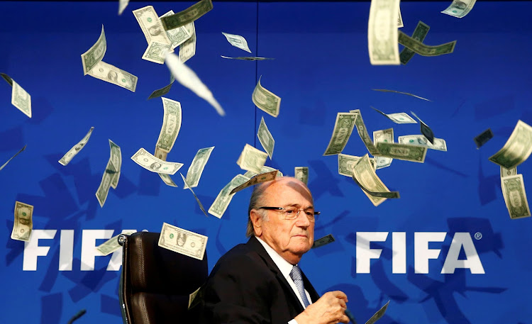 A file photo of a British comedian known as Lee Nelson (unseen) throws banknotes at then Fifa president (pictured) Sepp Blatter after he arrives for a news conference after the Extraordinary Executive Committee Meeting at the Fifa headquarters in Zurich, Switzerland, July 20, 2015.