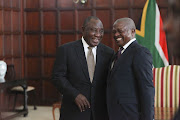 David Mabuza shares a lighthearted moment with President Cyril Ramaphosa after being sworn in as a member of parliament at the presidential guesthouse Sefako Makgatho in Pretoria on May 28 2019. 