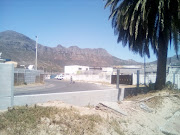 Photographs of the damaged section of the new security wall in Hout Bay show panels missing and  smashed on the ground.