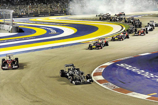 LEADER OF THE PACK: British Formula One driver Lewis Hamilton, centre, of Mercedes survived a heart-stopping moment towards the end of the race to win the Singapore Grand Prix yesterday