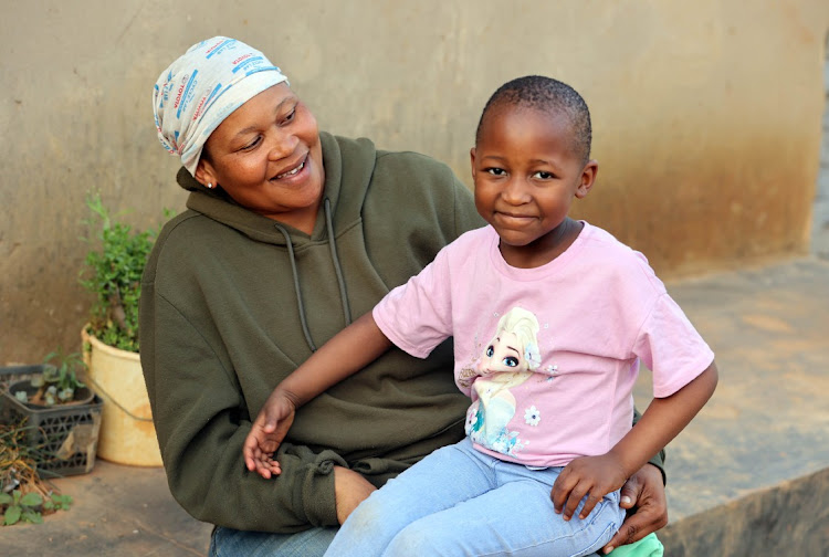 Molemo Modibogo, 5, with her mother Nkele is happy to be back home in Orange Farm, south of Johannesburg.