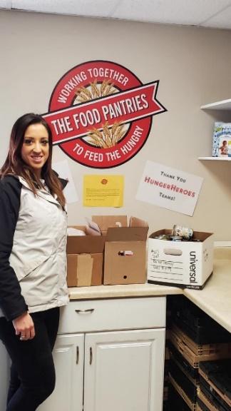 A person standing next to a counter with boxes on it

Description automatically generated with medium confidence