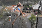 A house is left missing its roof after a tornado passed through the Eagle Point subdivision in Hoover, Alabama, on March 25 2021. 