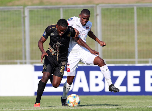 Victor Letsoalo of Royal AM is challenged by Zuko Mdunyelwa of Chippa United during the DStv Premiership match at the Chatsworth Stadium on Sunday