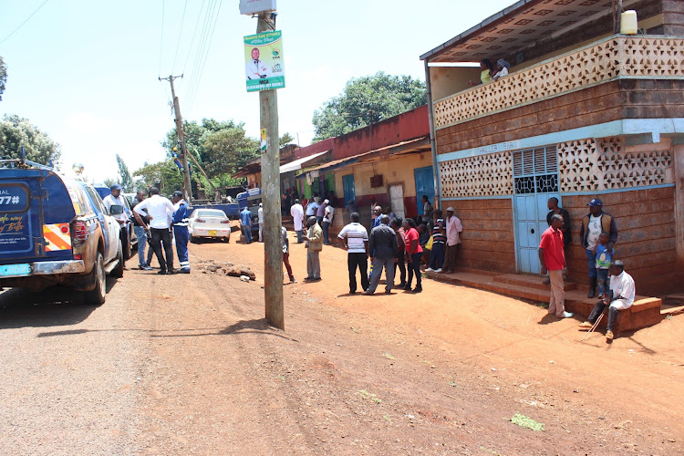 Residents of Kiawaihiga watch as Kenya Power workers replace a vandalized transformer on April 6, 2022.