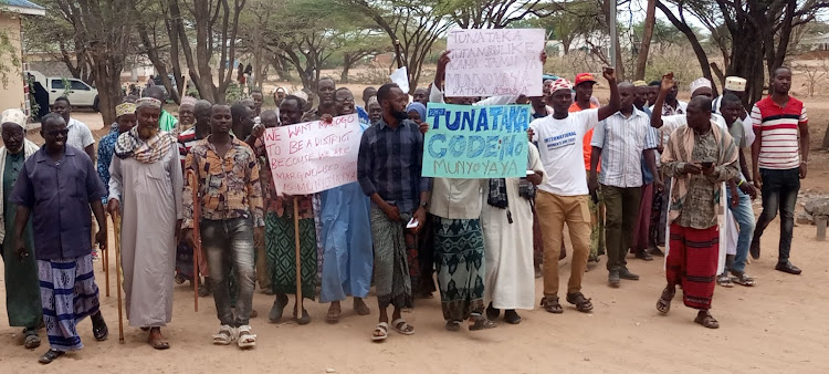 Munyo Yaya community members holding peaceful demonstration at Madogo trading center on Wednesday.