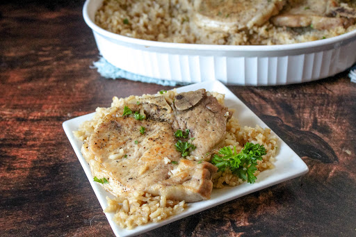 A plate of Connie's Pork Chops Over Rice.