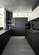 Matt black surfaces absorb light, so they work well in a bright space like this window-filled kitchen.