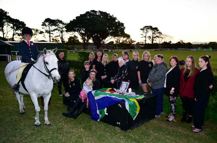 As riders from the Eastern Cape and Western Cape arrive at the PE Riding Club for the showjumping championships on Sunday, members of the club show their support on Thursday for murdered rider Meghan Cremer, posing with a SA flag and mementos in a minute of silence. Erin-Rae Retcliffe, who was sponsored by Cremer, sits on a pony named White Gold