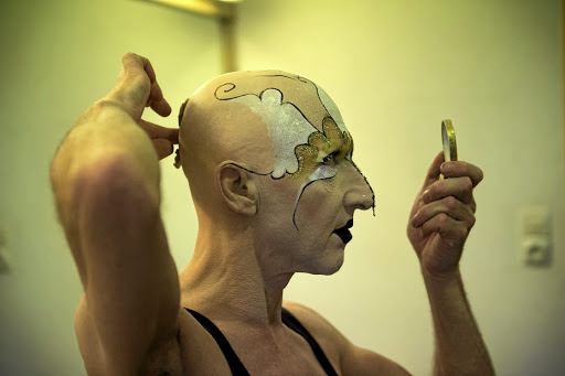 Steven Cohen applies the elaborate makeup he uses for his performance art. Afterwards, he will apply archival tape to his face to lift off a ‘print’ of it. The tapes have been reassembled to create works of their own.