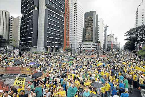 ANGER RISING: Demonstrators attend a protest against Brazil's President Dilma Rousseff in Paulista Avenue, Sao Paulo. Protest organisers in dozens of cities across Brazil are planning marches to pressure Rousseff over unpopular budget cuts and a corruption scandal that has snared leaders of her political coalition Picture: REUTERS