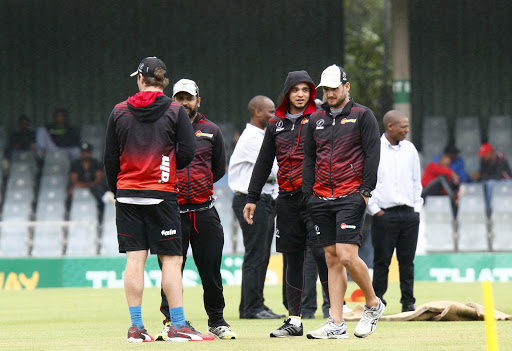 Warriors players discuss the conditions before the match.