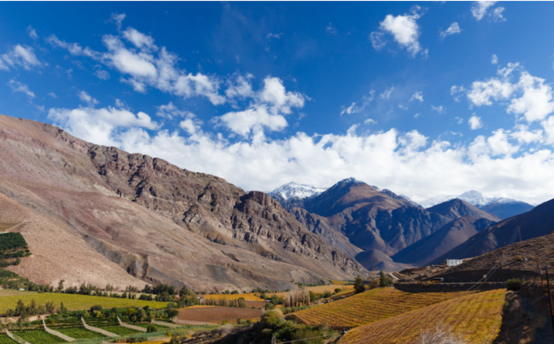 A canyon with a mountain in the background

Description automatically generated