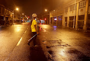 A man carries a golf club as a weapon while he patrols on Dr Yusuf Dadoo Avenue in Durban. Communities in Durban and surrounding areas were safeguarding their properties against criminality during the shutdown.  