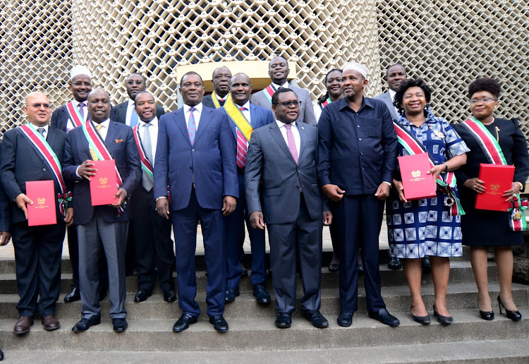 National Assembly Speaker Justin Muturi (2nd L), his Senate counterpart Kenneth Lusaka (C) and National Assembly Majority leader Aden Duale with the recipients of 2018 National Honours.