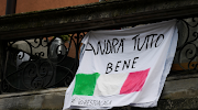 A banner with an Italian flag and reading 'All will be well' is seen, as the spread of Covid-19 continues in Milan, Italy, on March 20, 2020. 