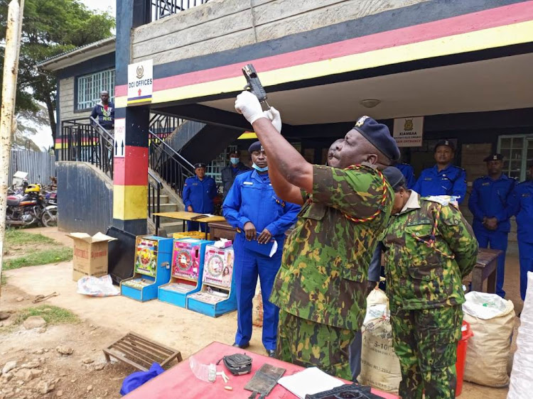 County commander Perminus Muchangi show the homemade gun at Kiambaa police station on July 27