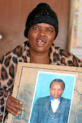 Matsatsi Sebetule holds a  picture of her late husband, Ngwako  Molewa,  who  died in GaMotupa,  Limpopo.  /ANTONIO MUCHAVE