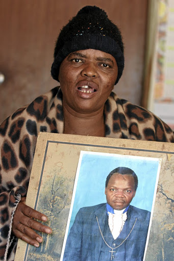 Matsatsi Sebetule holds a picture of her late husband, Ngwako Molewa, who died in GaMotupa, Limpopo. /ANTONIO MUCHAVE