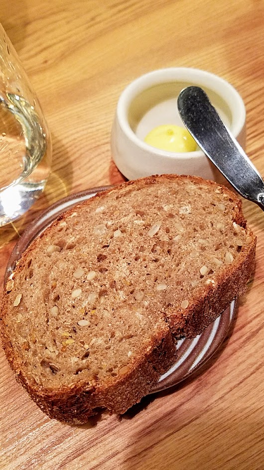 Farm Spirit 7:45 PM seating on December 16th dinner: each setting started off with a Seeded Rye bread accompanied by a vegan butter made from fresh pressed heritage seed canola oil with aquaphaba (chickpea juice)