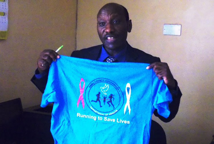 Embu Health executive Dr Jamleck Muturi displaying one of the T shirts that were sold to raise funds during a cancer Marathon for May 12, 2019, for raising funds to buy cancer drugs by Embu county government.