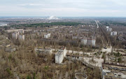 A New Safe Confinement (NSC) structure over the old sarcophagus covering the damaged fourth reactor at the Chernobyl Nuclear Power Plant is seen behind the abandoned town of Pripyat, Ukraine, on April 12 2021. File photo.