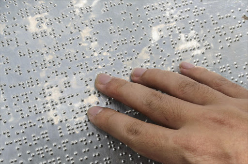 Hand reading braille - Stock image