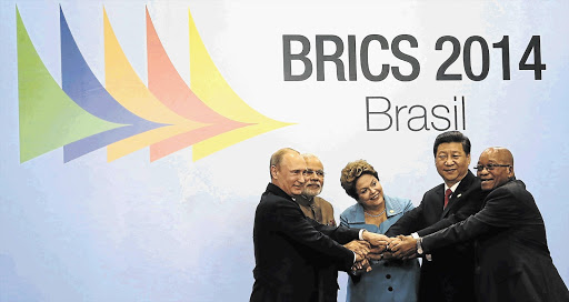 LENDING A HAND: Russian president Vladimir Putin, Indian prime minister Narendra Modi, Brazilian president Dilma Rousseff, Chinese president Xi Jinping and President Jacob Zuma pose for a group photo session during the sixth Brics summit in Fortaleza, Brazil