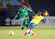 Neo Maema of Mamelodi Sundowns is challenged by Philippe Arthur Banen of Coton Sport in the Caf Champions League Group B match at Loftus Stadium in Pretoria on April 1 2023.