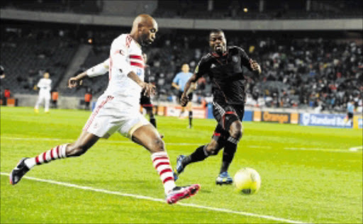 FIRST BLOOD TO BUCS: Zamalek's winger Mahmoud Abdel Razek Hassan Fadlalla, left, is challenged by Orlando Pirates defender Rooi Mahamutsa during their Champions League match at Orlando Stadium in SowetoPhoto: Gallo Images