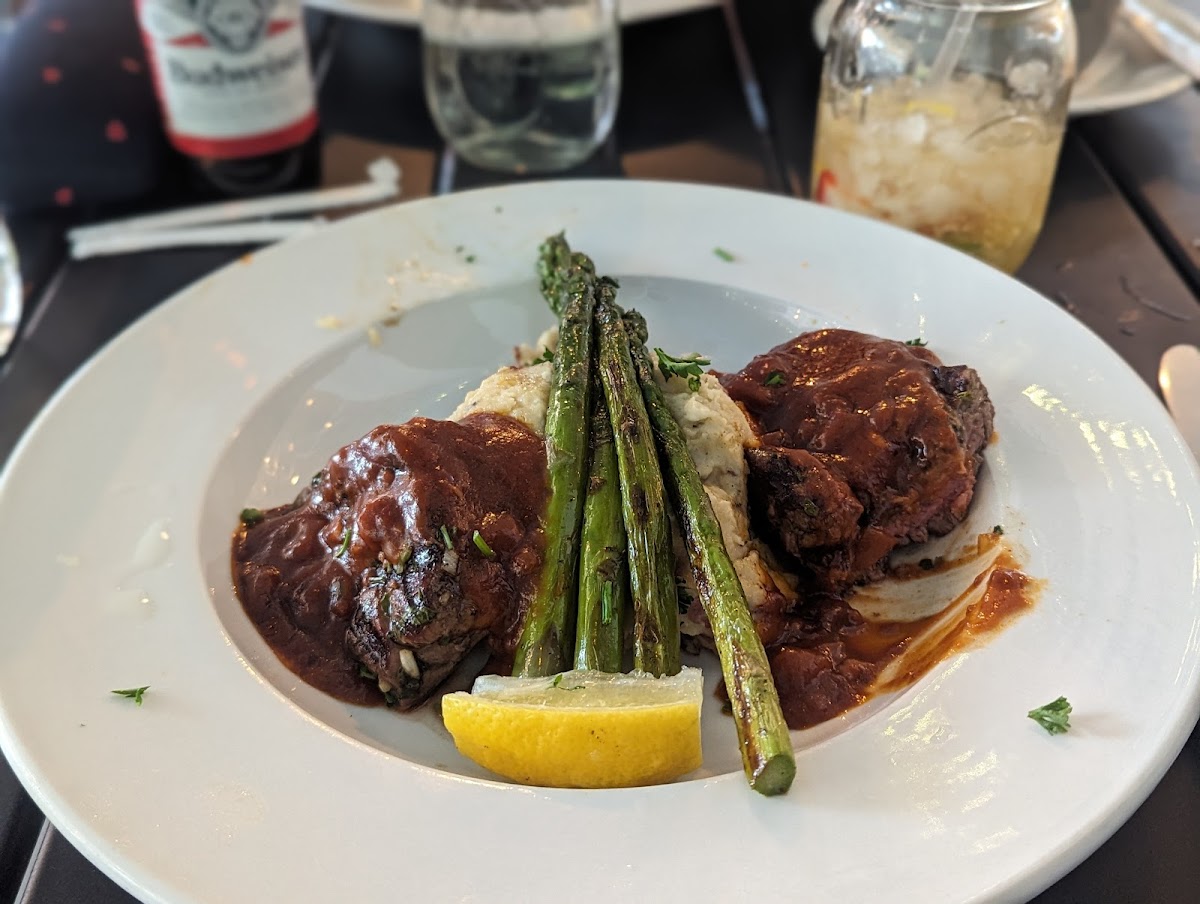Filet medallions with red wine reduction, mashed red potatoes, and grilled asparagus