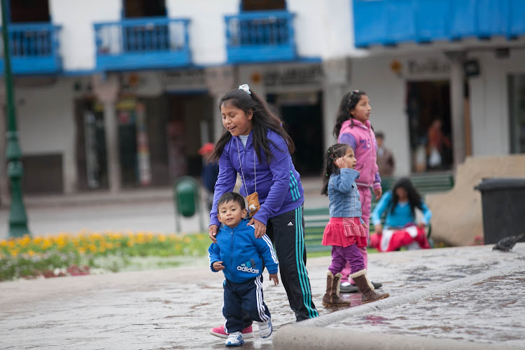  Local kids playing at Plaza De Armas in the center of Cusco, Peru. 