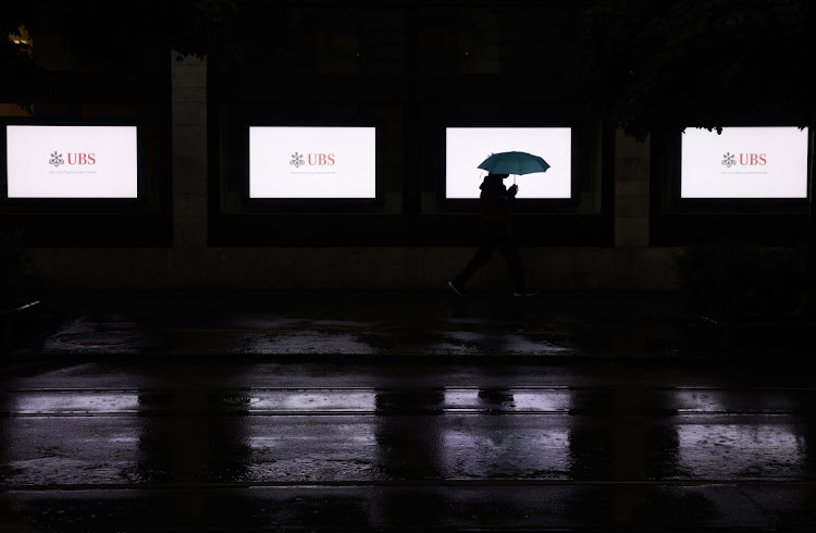 A pedestrian passes outside a UBS bank branch at night in Zurich, Switzerland, July 13 2021. Picture: STEFAN WERMUTH/BLOOMBERG