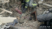 Rescuers remove a woman from debris after a military strike, as Russia's attack on Ukraine continues, in the town of Rubizhne, in Luhansk region, Ukraine April 6, 2022. 