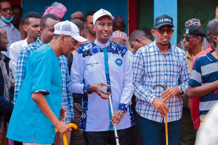 Wajir governor Mohamed Abdi[C] his running mate Abdifatah Diriye [R] Wajir senate candidate Adow Mohammed Abikar [L] in lehey town on July 19th. they have all quit from the race.