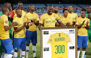 Mamelodi Sundowns captain Hlompho Kekana celebrates his 300th games with coach Pitso Mosimane and teammates.