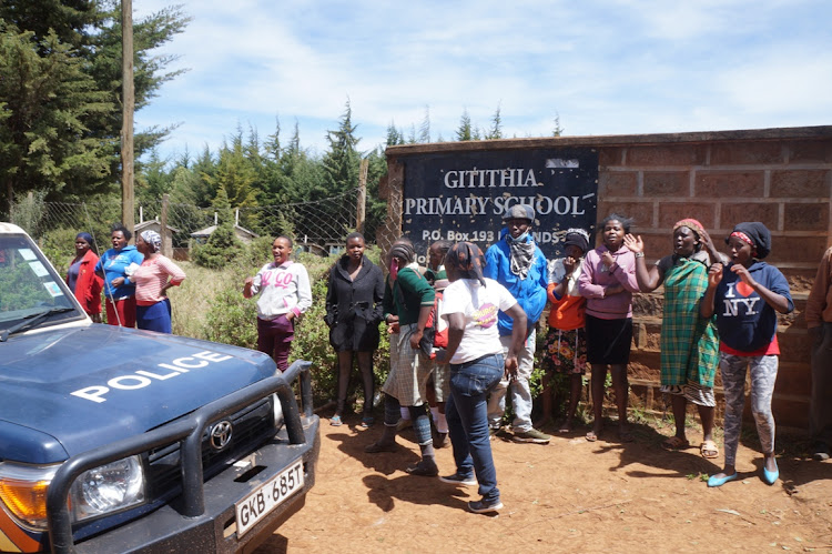 Parents at the gate of Gitithia Primary School on Friday.