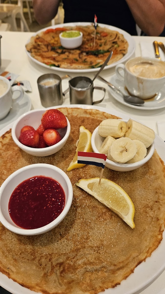 Lemon, sugar,  banana and strawberry pancake with raspberry sauce.  And a savoury pancake with vegies.