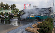 Riot police officers control traffic after a bus was torched by unknown people ahead of protests by supporters of Kenya's opposition leader Raila Odinga of the Azimio La Umoja (Declaration of Unity) One Kenya Alliance, in a nationwide protest over cost of living and President William Ruto's government in Nairobi, Kenya May 2, 2023.