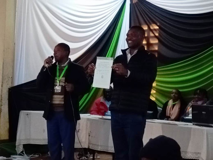 Gichugu MP-elect Gichimu Githinji displays his certificate after he was declared winner in Tuesday's election.