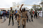 Sri Lankan military officials stand guard in front of the St Anthony's Shrine, Kochchikade church, after an explosion in Colombo, Sri Lanka, on April 21 2019. 

