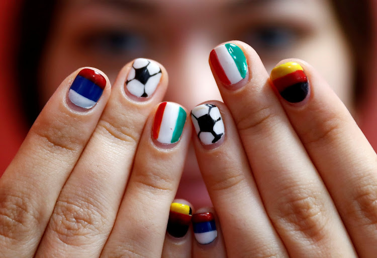 Volunteer Ekaterina Semenova poses with painted fingernails at the media centre of Kaliningrad Stadium in Russia during the 2018 World Cup.