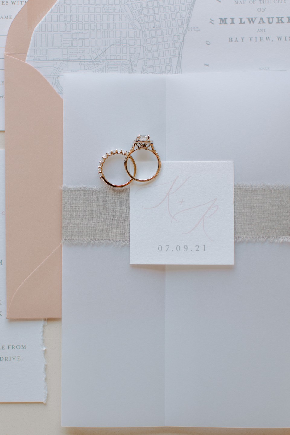 delicate wedding invites with rings overlayed