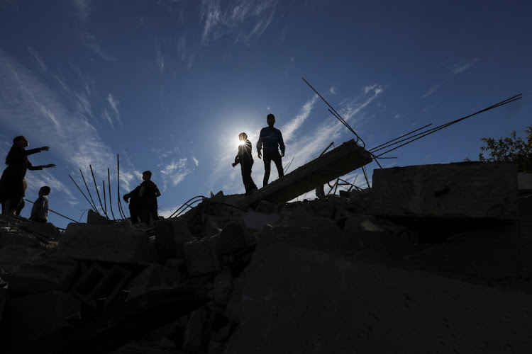 Palestinians inspect the site of an Israeli strike on a house, amid the ongoing conflict between Israel and Hamas, in Rafah, in the southern Gaza Strip, on December 16 2023.