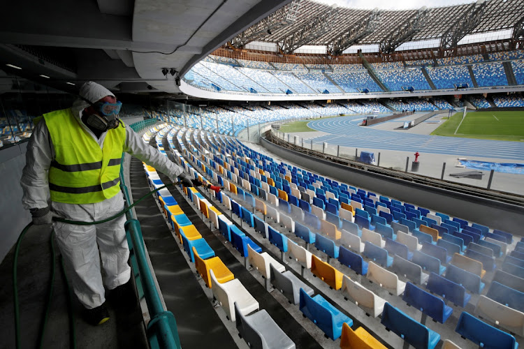 A cleaner sprays seats at the San Paolo stadium in Naples, Italy. With the sporting world hit hard by the coronavirus outbreak, the World Football Summit is due to be held in Durban this week.