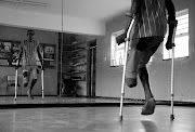 Amputee dancer Sphamandla Sithole dancing on crutches during a rehearsal session at the Transhaven Centre where the Wentworth Arts and Culture Organisation studio is located.