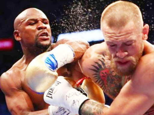 Conor McGregor trades punches with Floyd Mayweather during a past bout